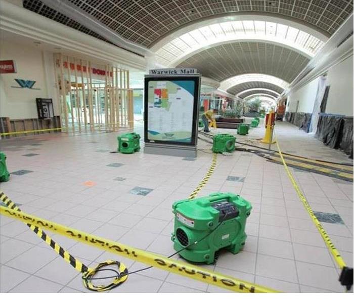 green drying equipment on tile floor in mall